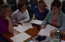 four women reviewing documentation